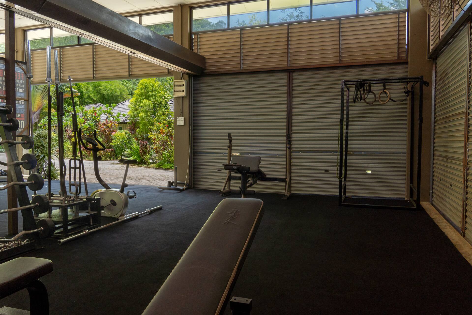 Full gym with squat racks, free weights, and cable machines at Bambu