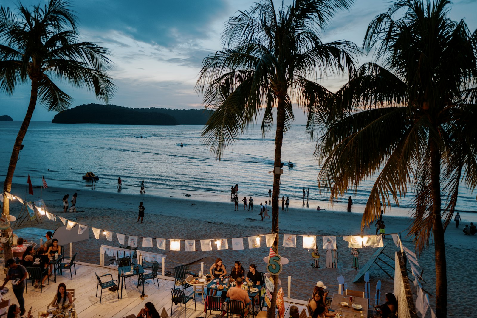 People relaxing on a sandy beach, Langkawi