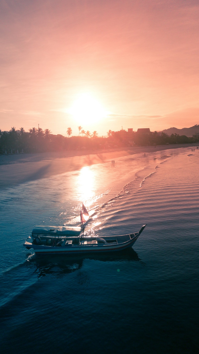 Boats and warm sunset light over the Andaman Sea near Langkawi