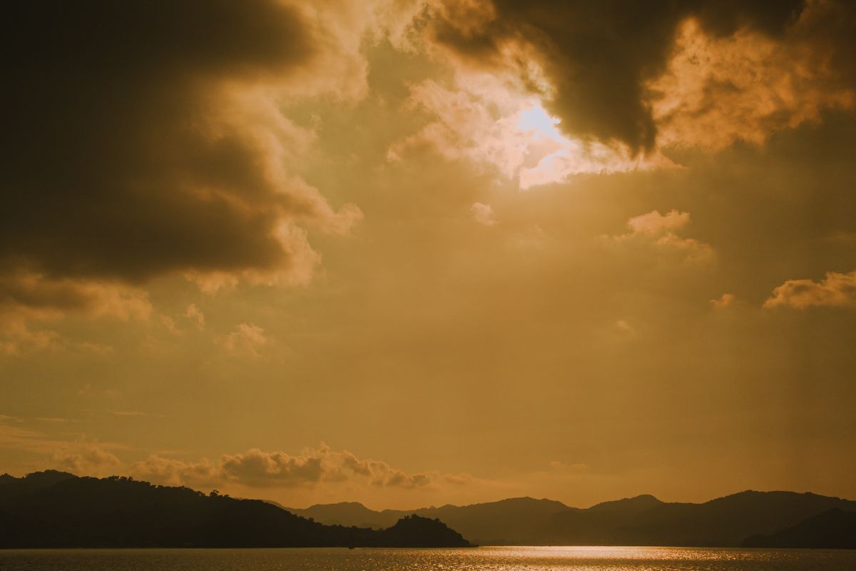 Golden sunset light over the Langkawi coastline and distant hills